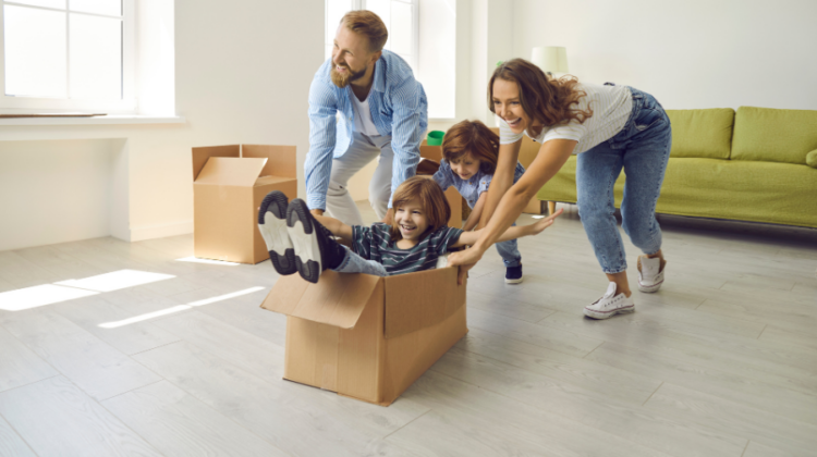 family with moving boxes having fun