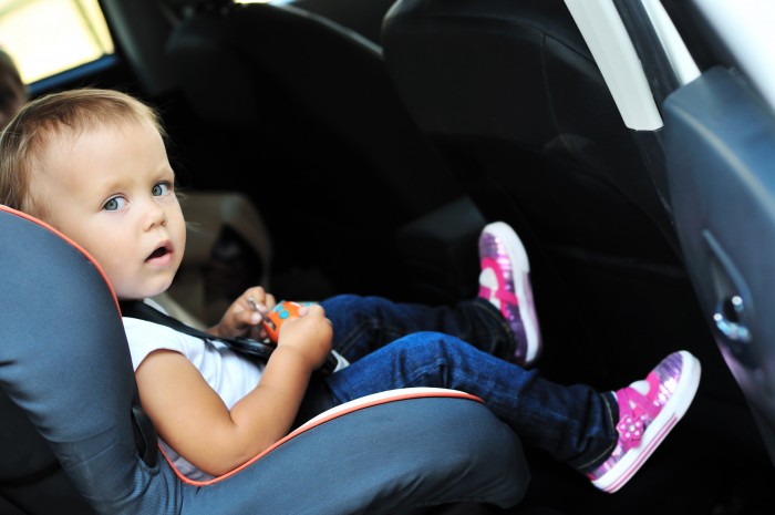cute toddler girl in car seat
