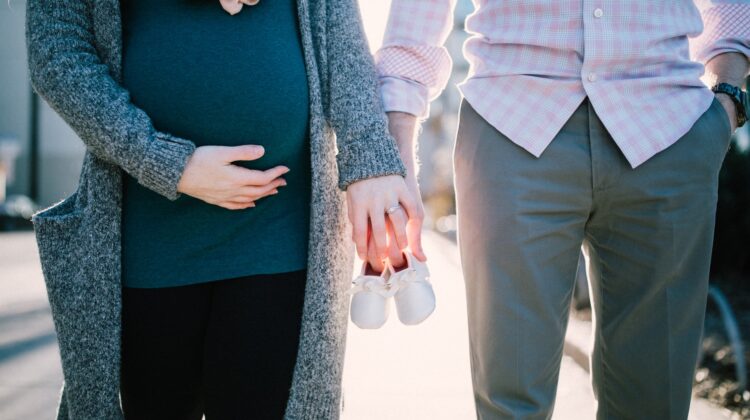 Pregnant Couple Holding Hands