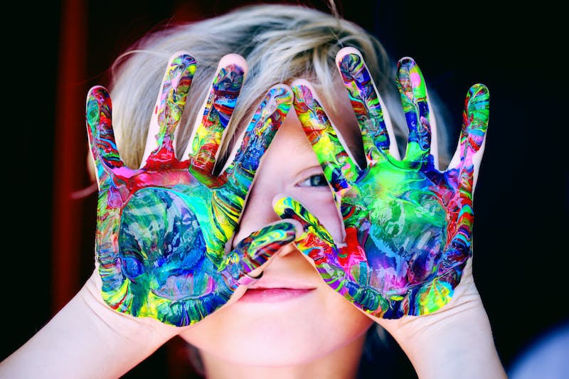 child wit painted hands