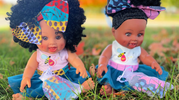 2 baby dolls in the grass