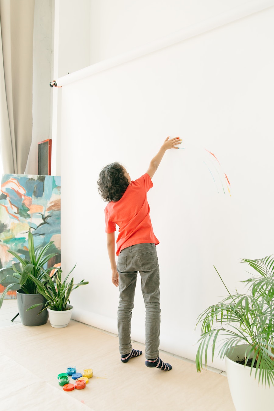 boy painting on wall 
