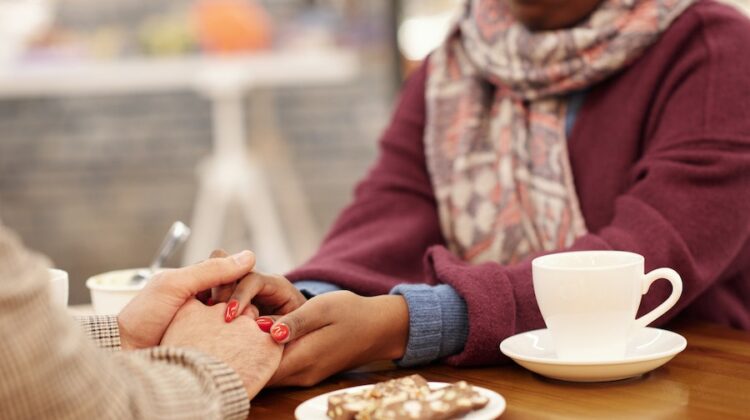couple holding hands over a table