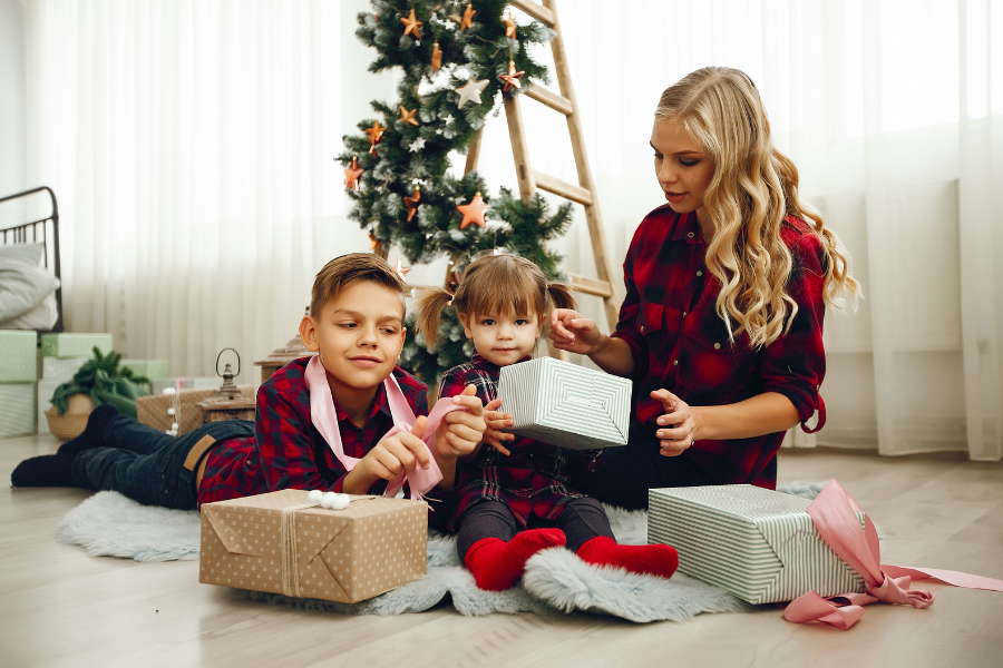 gift for kids with mom under Christmas tree