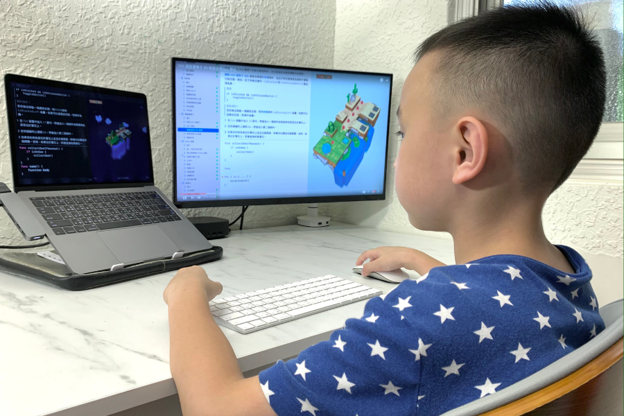boy coding at computer