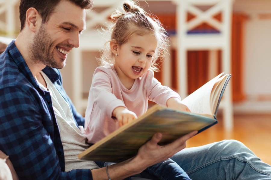 dad and toddler reading book