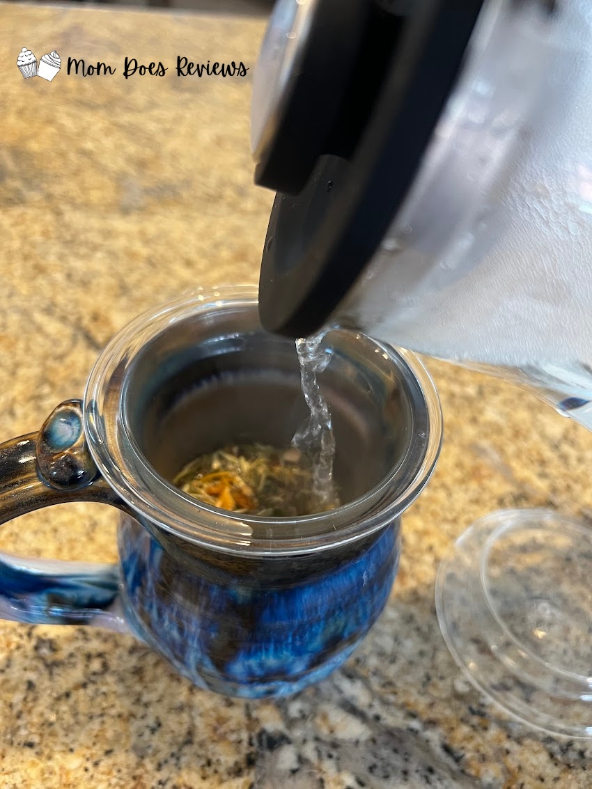 Teabloom glass infuser with water pouring over tea leaves
