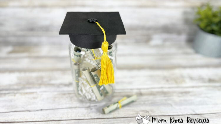 Using simple supplies from the Dollar Store, create this quick and easy Mason Jar Grad Cap craft in just 30 minutes. Not only can it be a keepsake, but it is filled with money and we all know that money is a grad's favorite gift! Keep reading to find out how to make your own Dollar Store Mason Jar Grad Cap Craft.