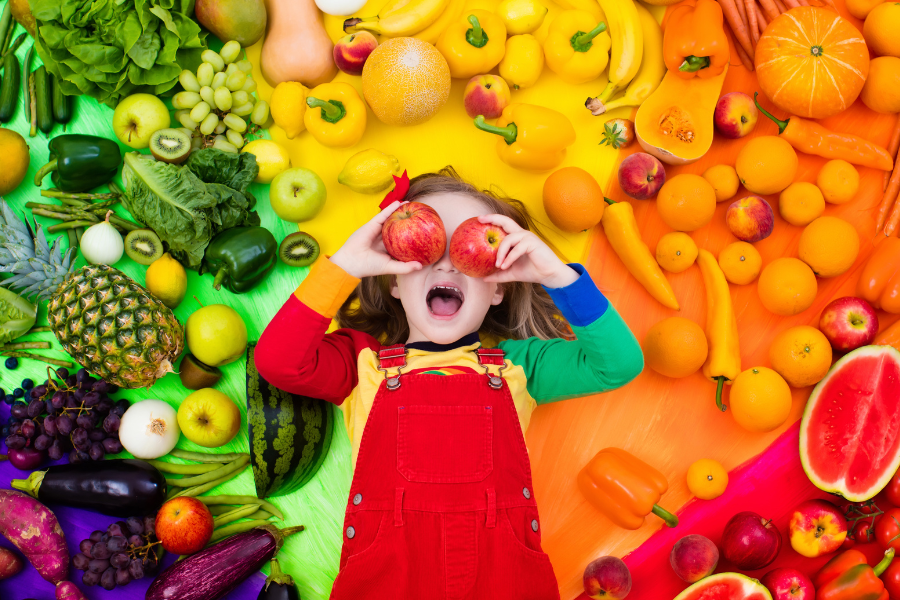 kid with bright healthy fruits