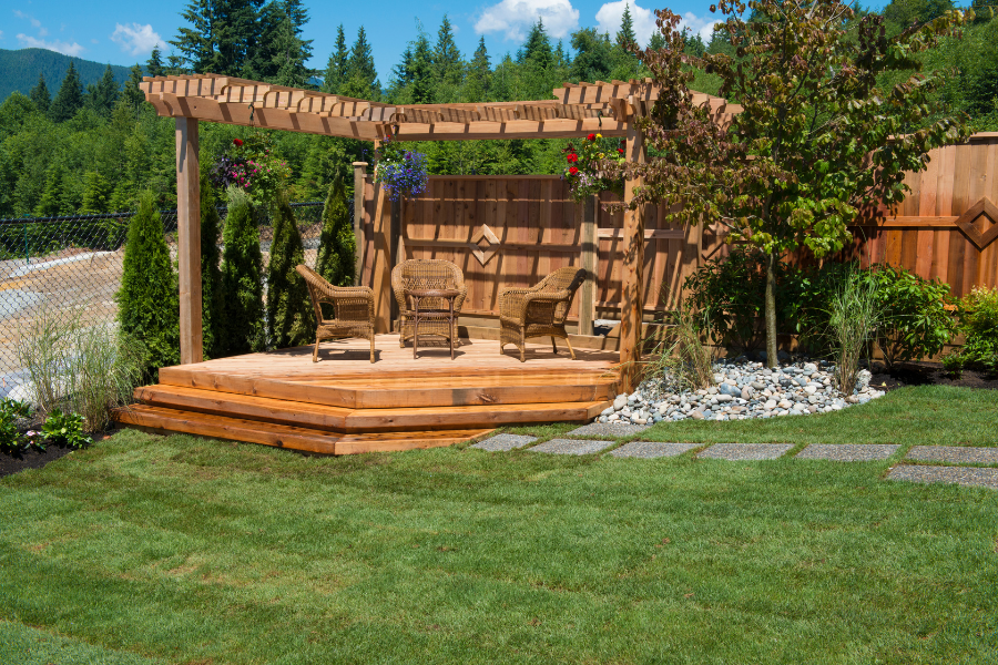 grass yard with deck and pergola