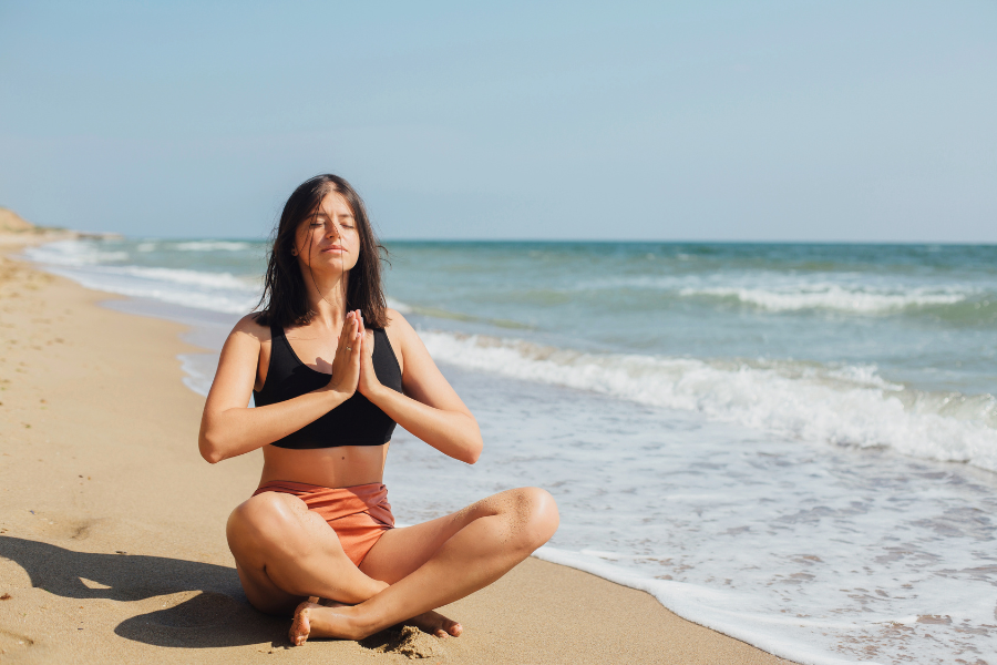 lady sitting on beach relaxing
