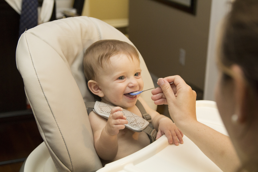 baby eating in highchair 