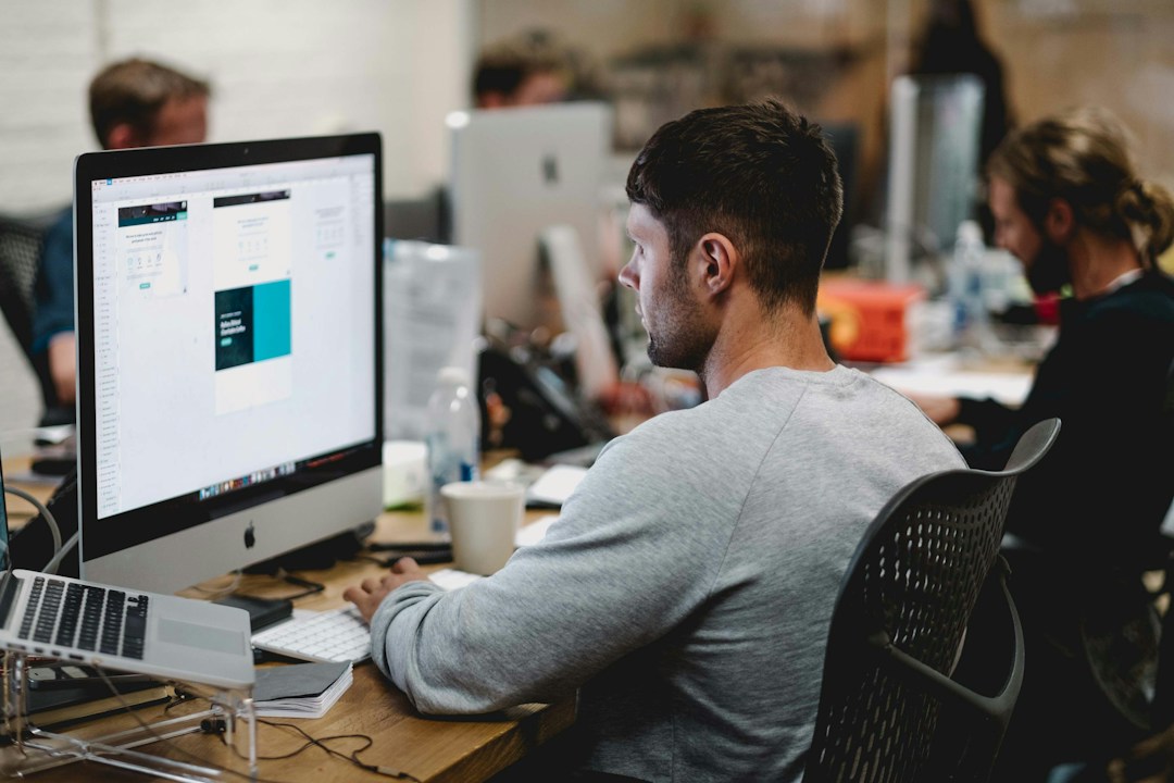 A man in an office researching CTI on his computer