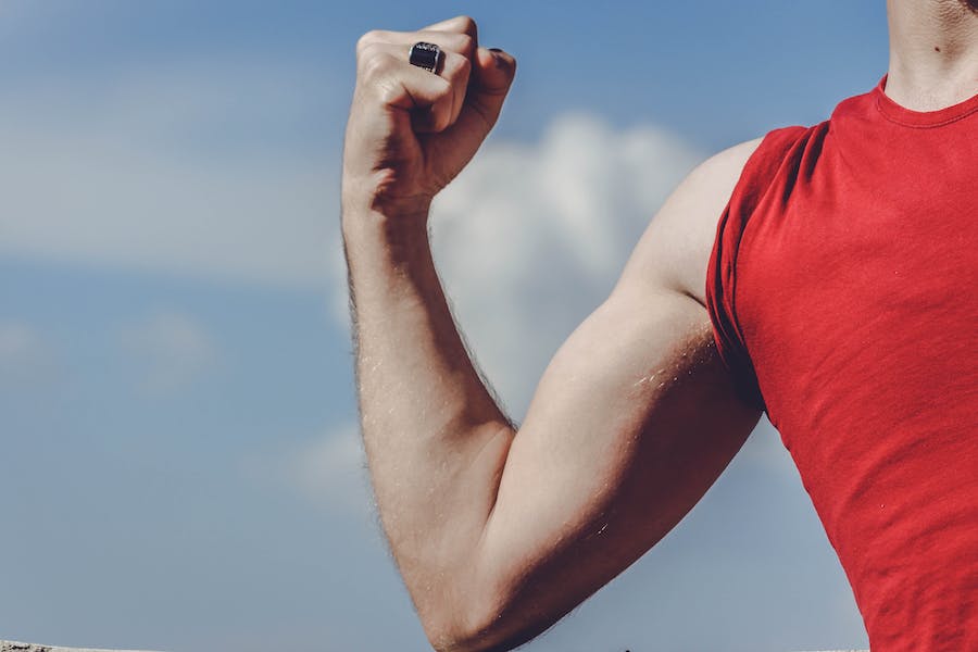 man raising right arm
