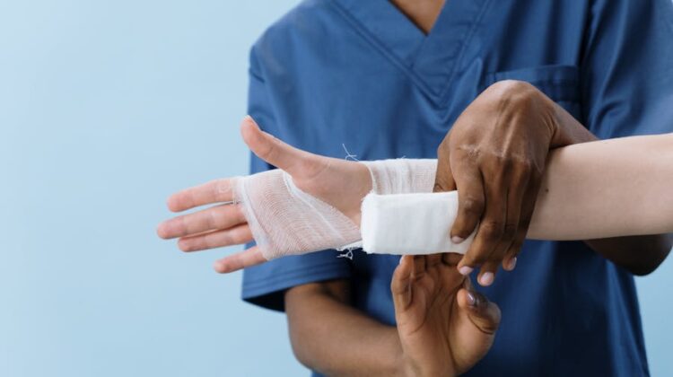 hand being bandaged