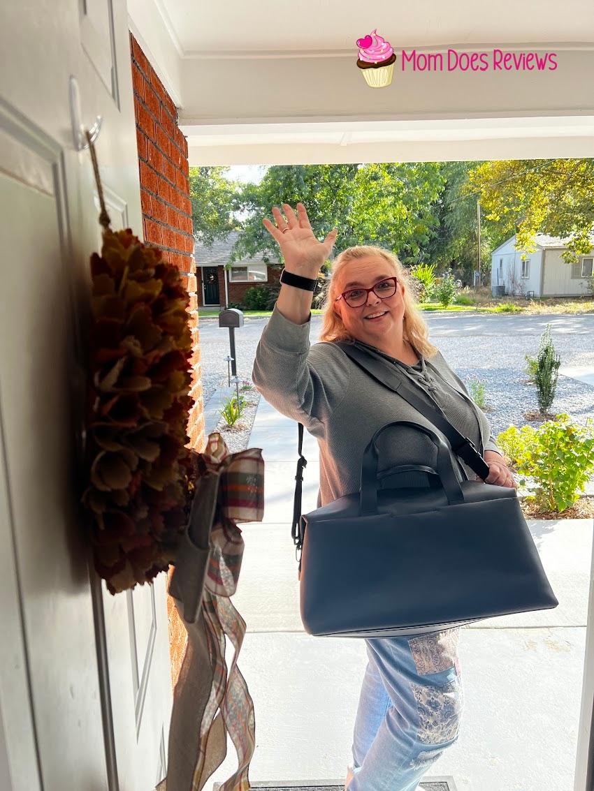 Woman with Troubadour duffle waving goodbye