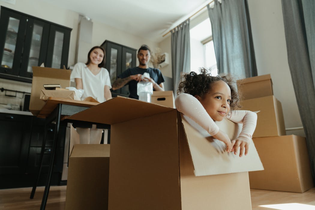 little girl in moving boxes