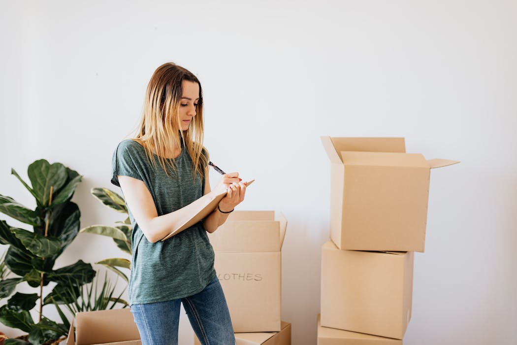 woman with boxes writing notes