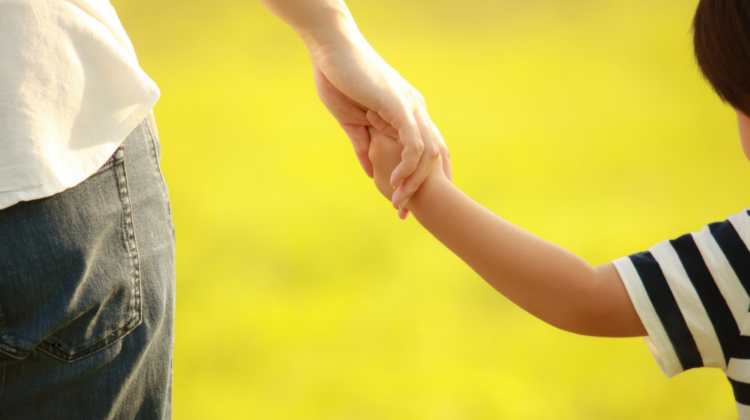 parent holding child's hand