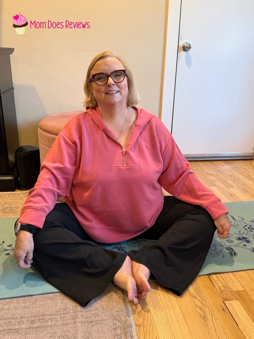 Woman sitting on a yoga mat in Stelle fleece-lined flare leggings