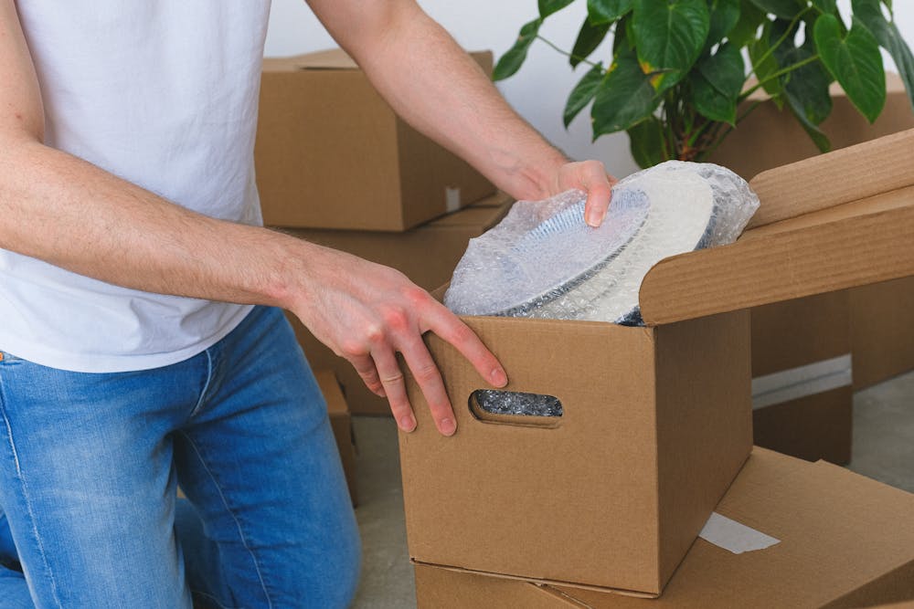 moving house packing a box