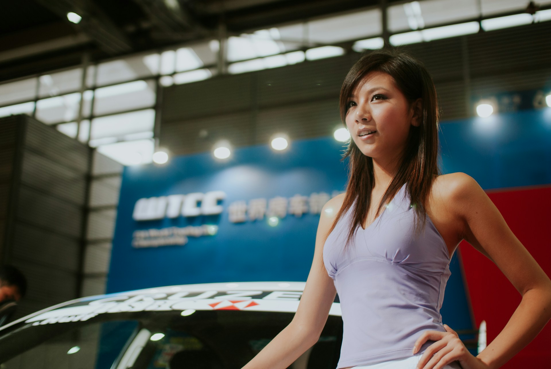 woman poses by car