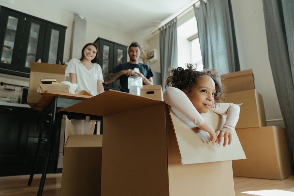 little girl in moving boxes