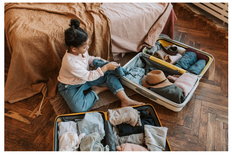 child with suitcases
