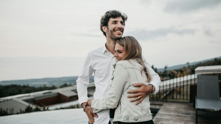 man and woman hugging