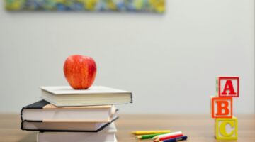 red apple and books