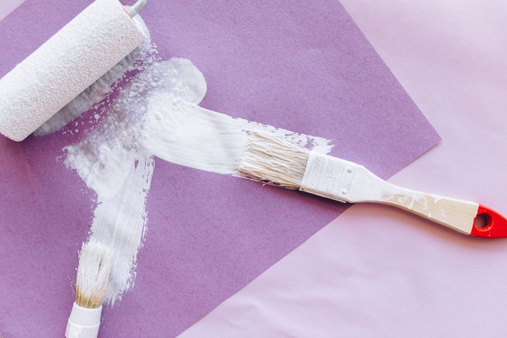 White paint on purple paper