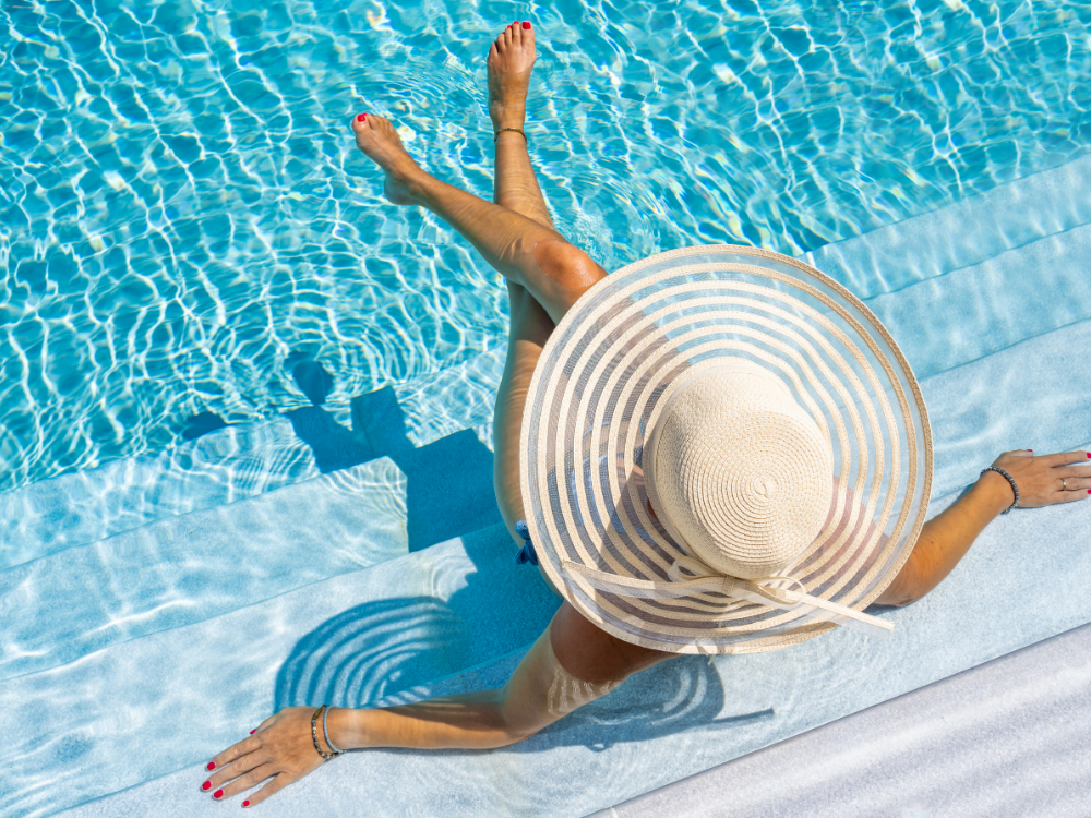 woman in pool with hat