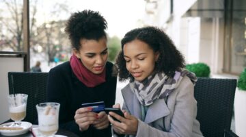 2 women looking at smartphone