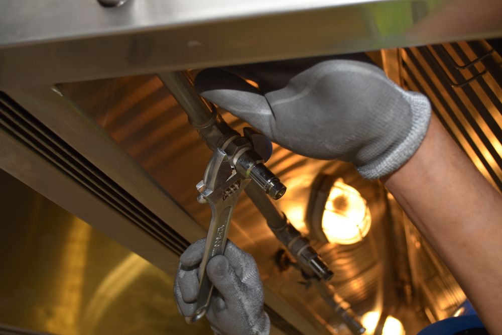 close up of man using a wrench plumbing problems