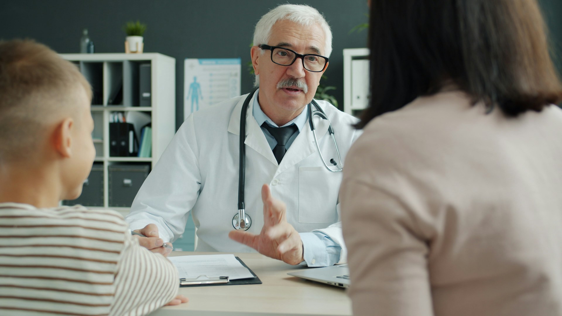 doctor consults with mom and child