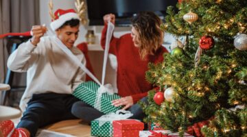 man and woman opening presents