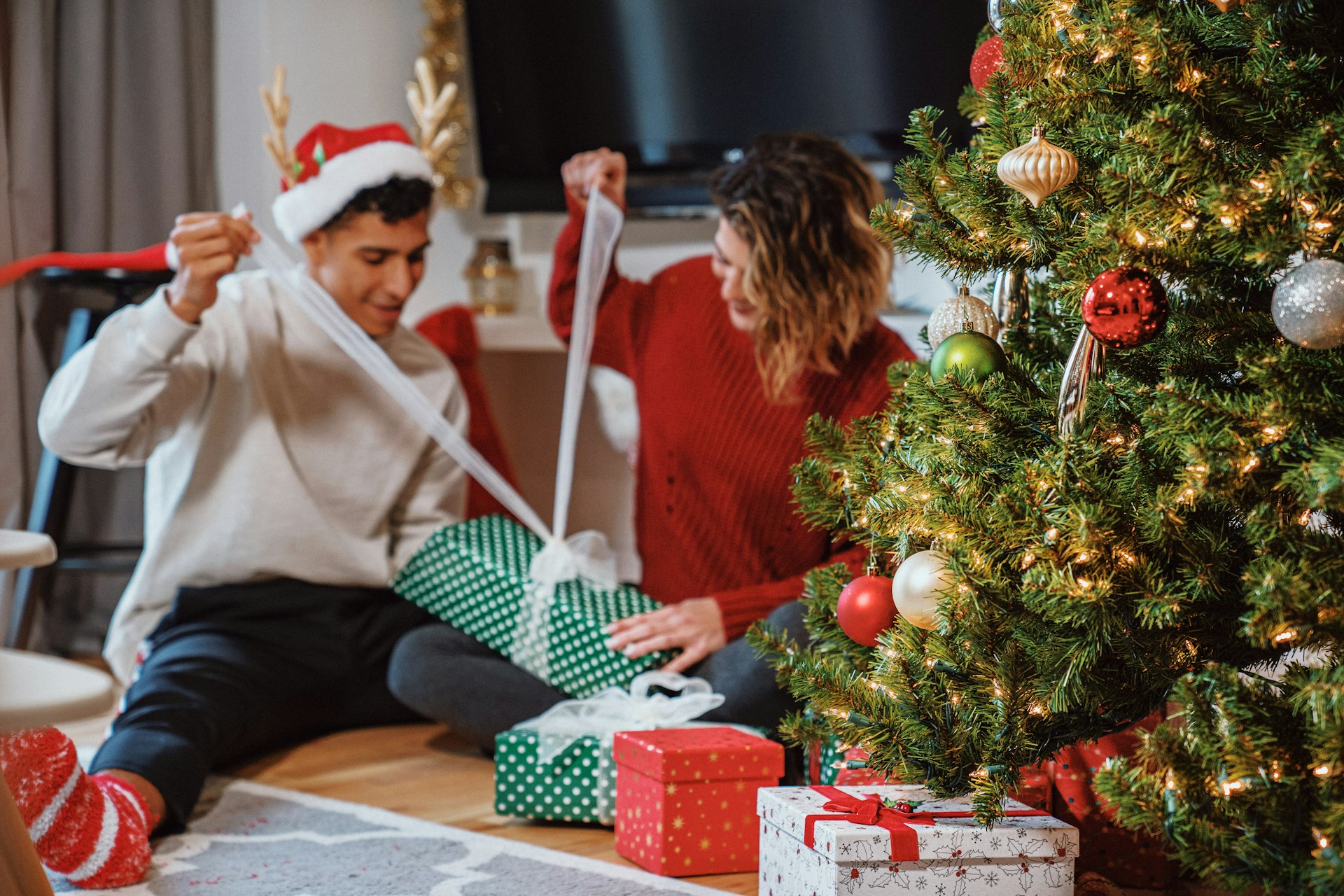 man and woman opening presents