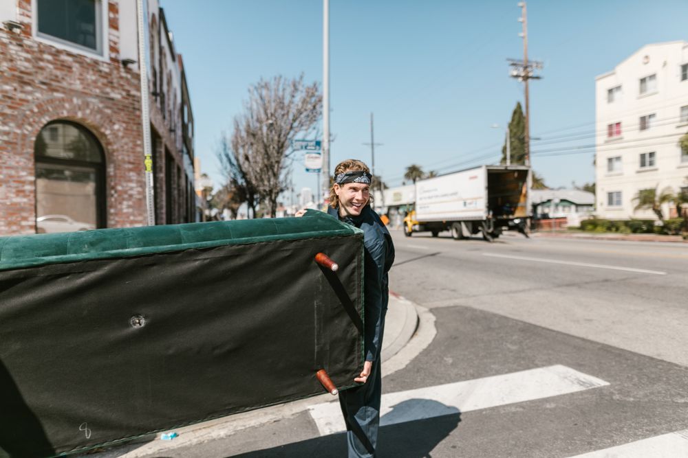 man moving couch