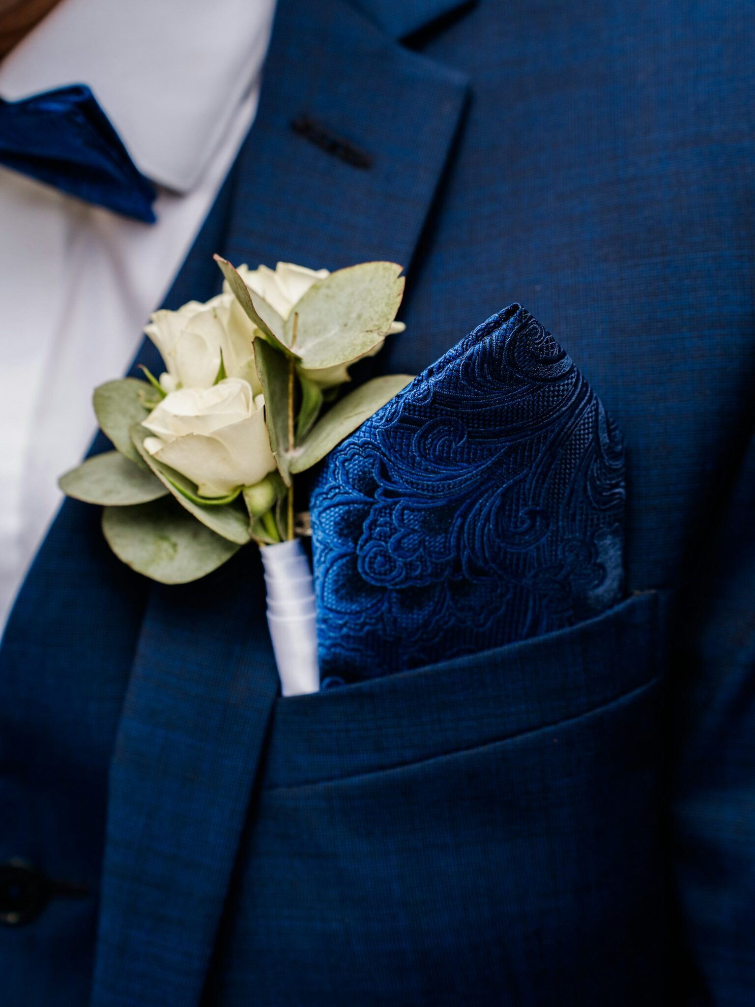 navy blue suit with flower