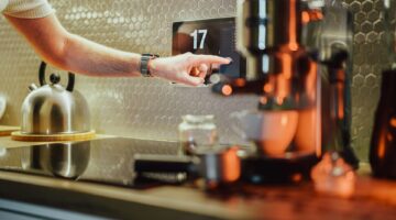 pressing button on coffee machine