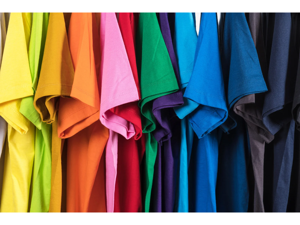 Set of multicolored shirts hanging in a row