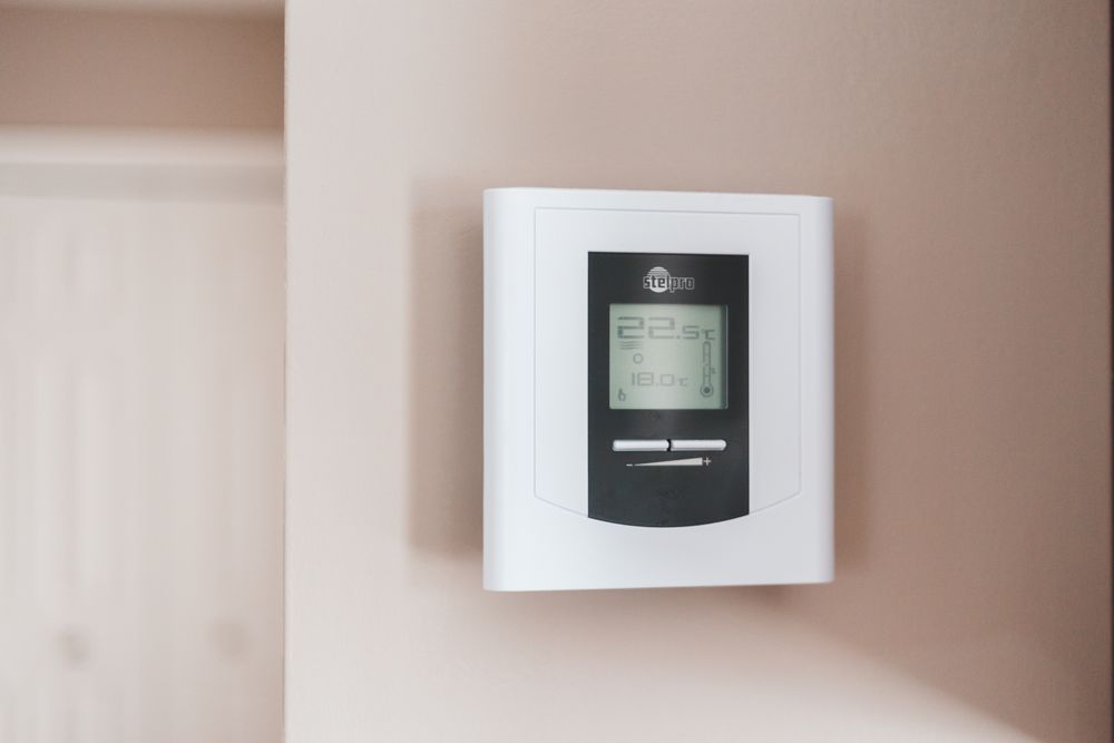 white thermostat on the wall