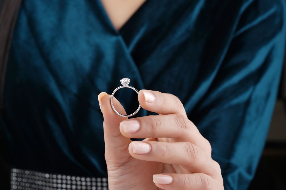 woman holding a diamond ring