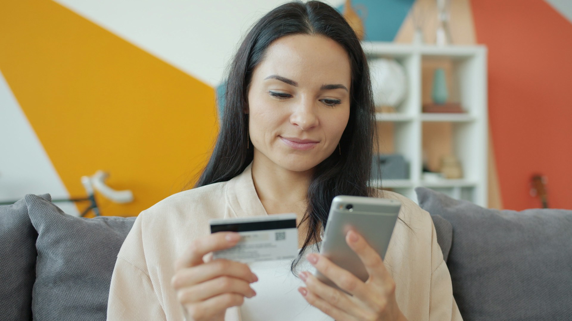 woman using smartphone with credit card