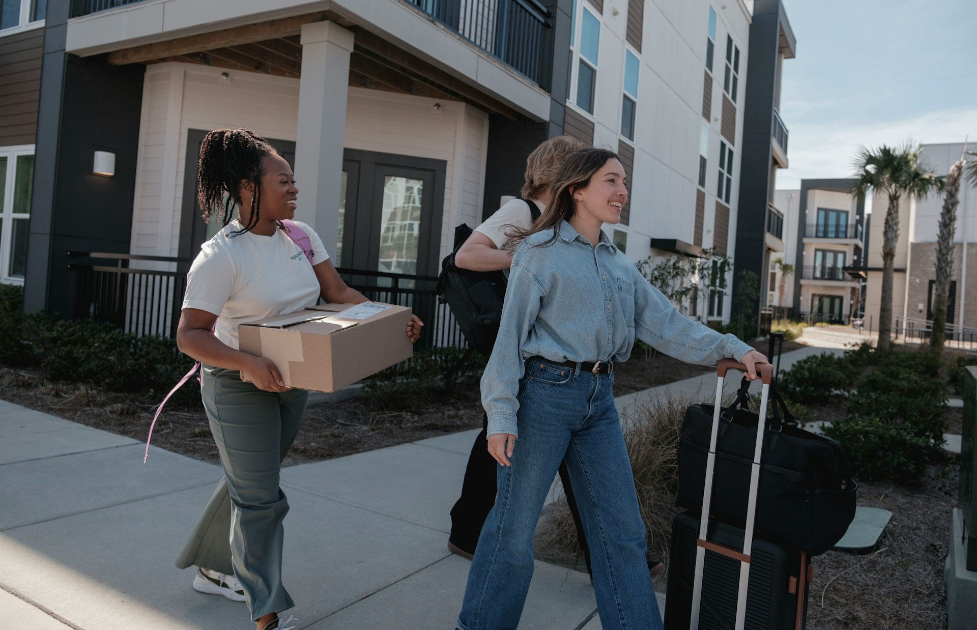young people carrying boxes
